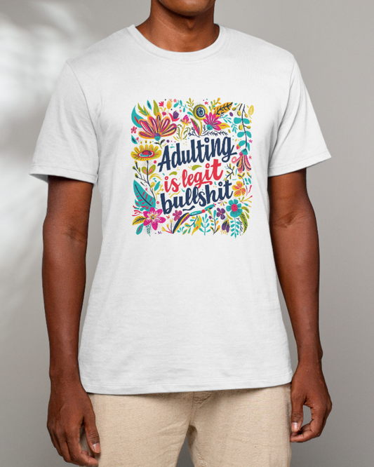Person wearing a white t-shirt with colorful graphic and text on a plain background